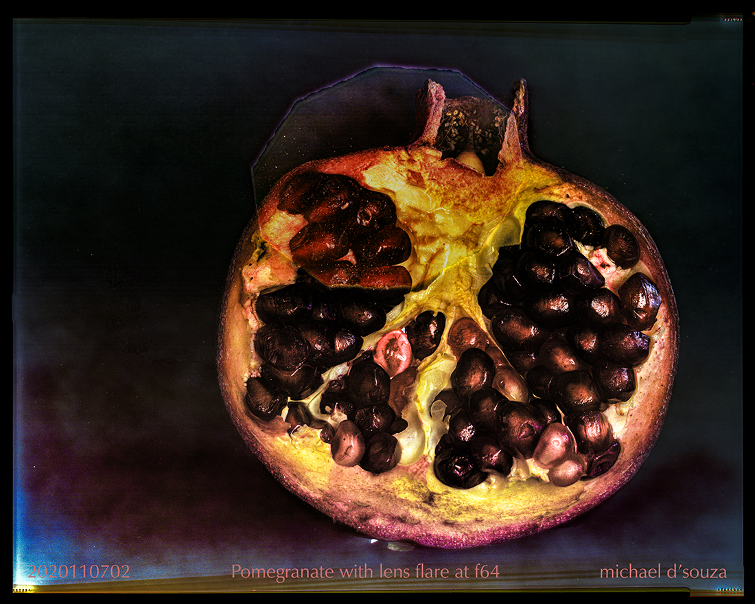 Pomegranate with lens flare at f64